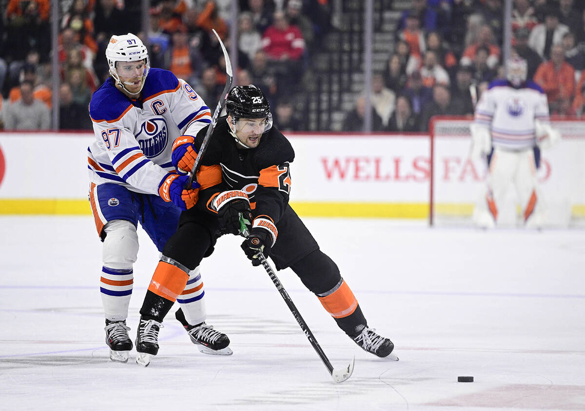 Philadelphia Flyers' James van Riemsdyk, right, plays the puck past Edmonton Oilers' Connor McD ...