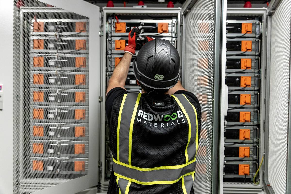 A Redwood Materials worker reaches for a battery pack. (Courtesy of Redwood Materials)