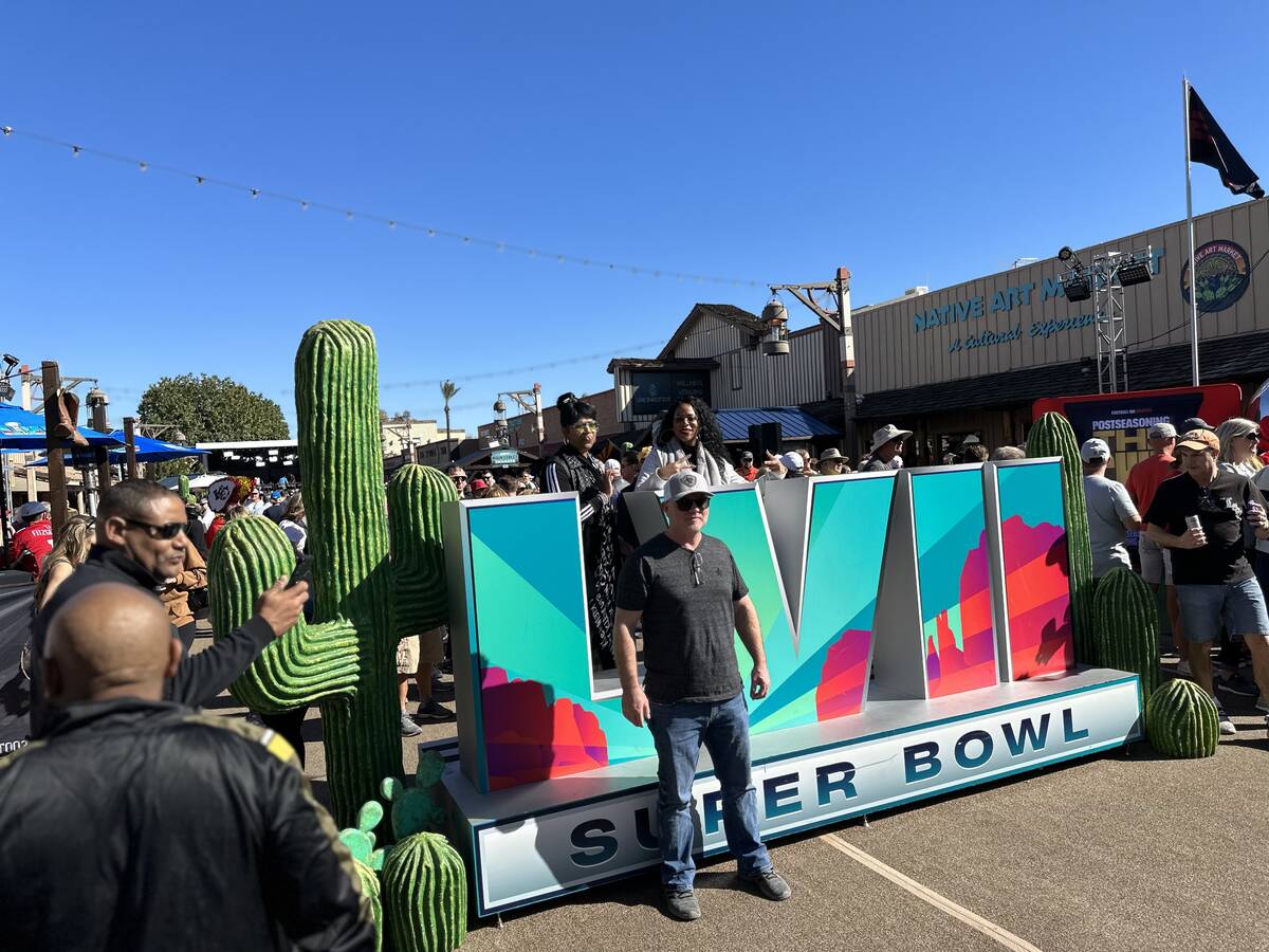 Joy Gardner and Zakia Johnson pose above the Super Bowl LVII sign at the ESPN Main Street Tailg ...