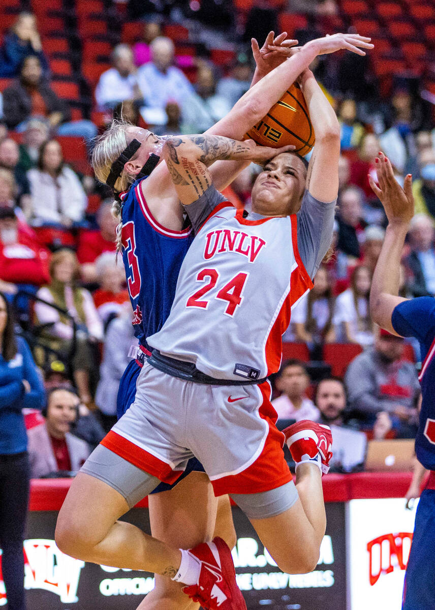 UNLV Lady Rebels guard Essence Booker (24) fights to get a shot off while fouled by Fresno Stat ...