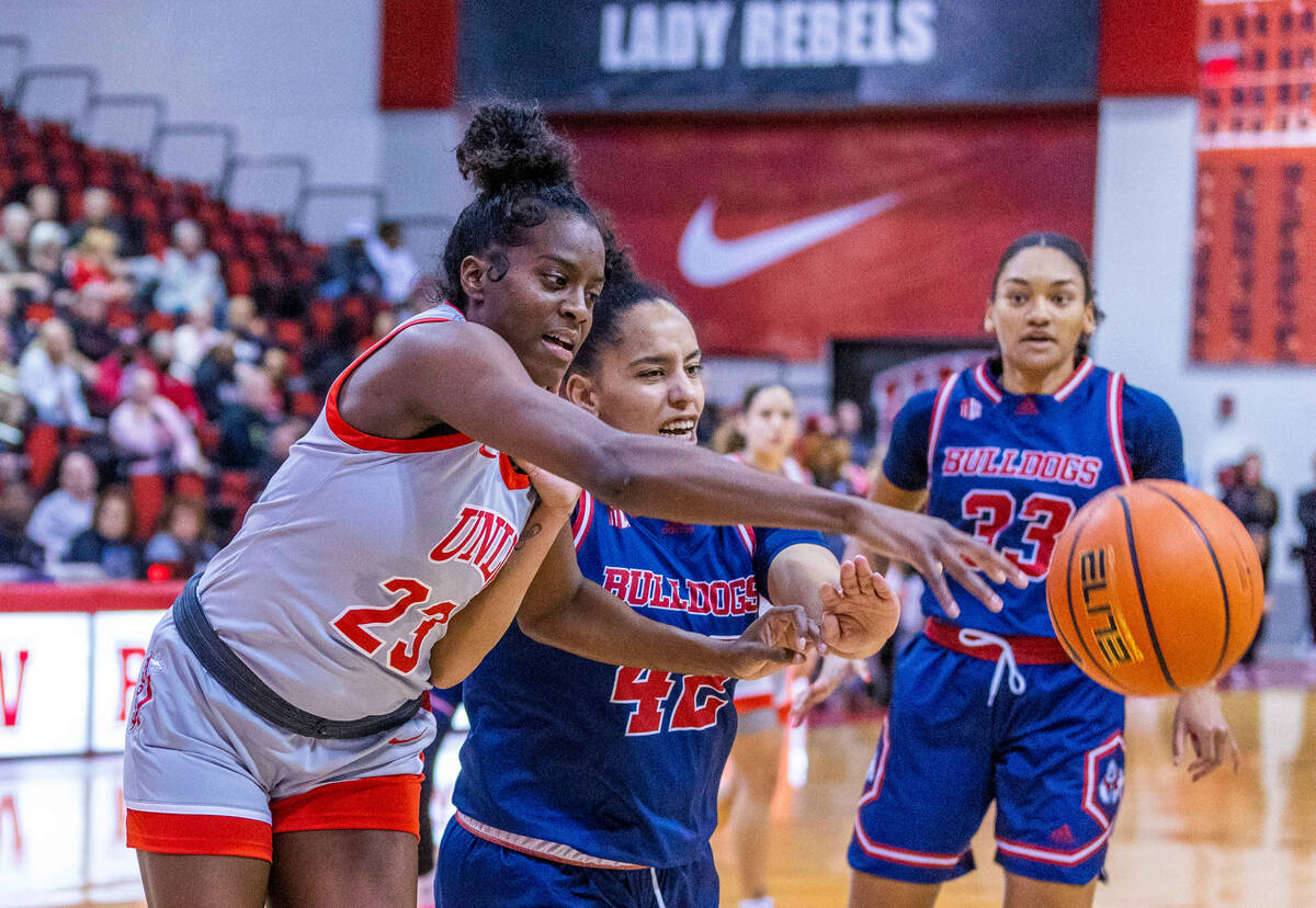 UNLV Lady Rebels center Desi-Rae Young (23) pokes away a rebound attempt by Fresno State Bulldo ...