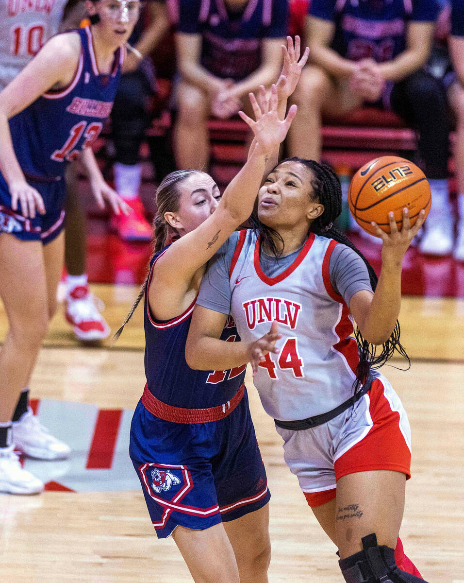 UNLV Lady Rebels forward Alyssa Brown (44) looks to get off a shot around Fresno State Bulldogs ...