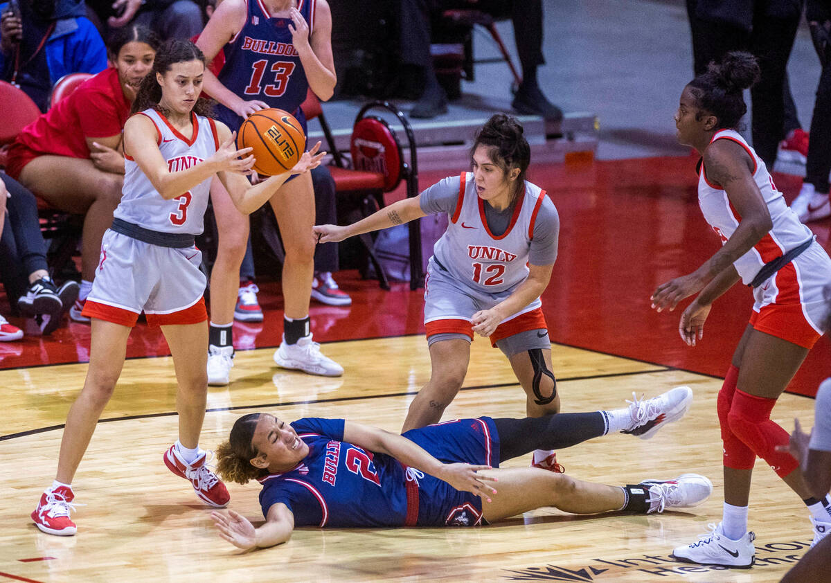 UNLV Lady Rebels guard Kiara Jackson (3) grabs a loose ball after Fresno State Bulldogs forward ...
