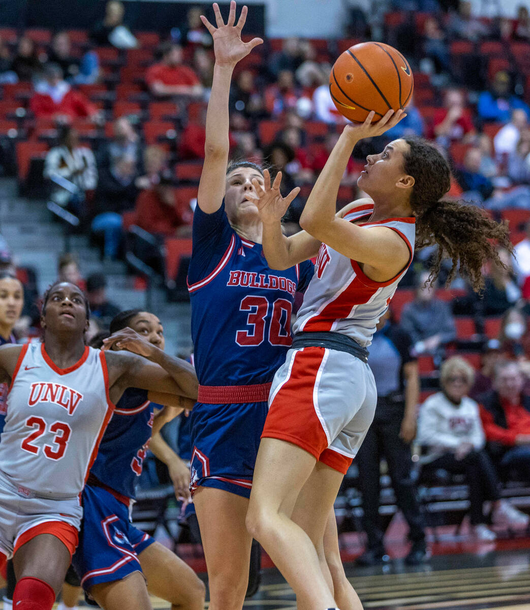 UNLV Lady Rebels guard Essence Booker (24) sets up a shot over Fresno State Bulldogs guard Yani ...