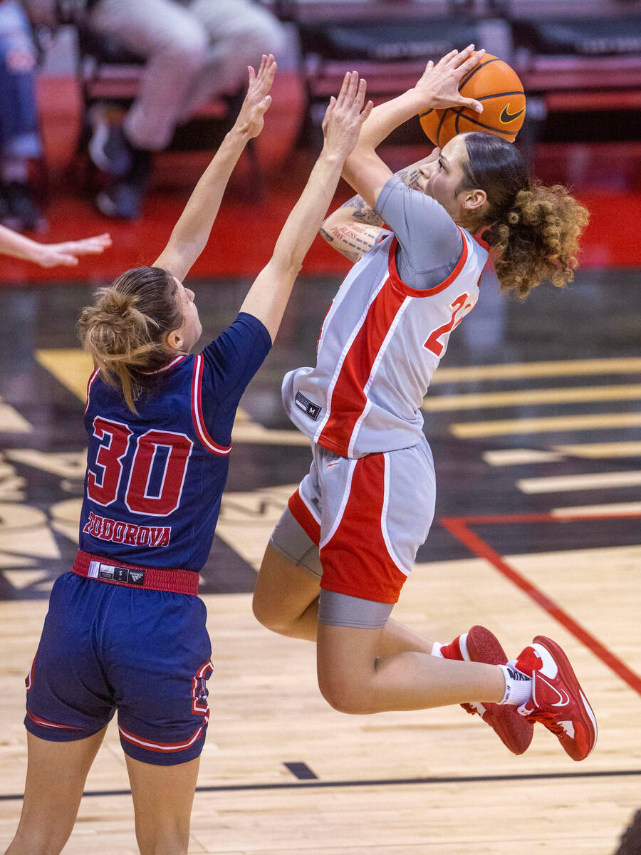 UNLV Lady Rebels guard Essence Booker (24) elevates to short over Fresno State Bulldogs guard Y ...