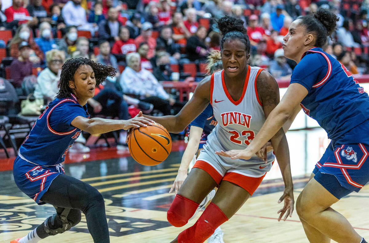 UNLV Lady Rebels center Desi-Rae Young (23) works to split the defense of Fresno State Bulldogs ...