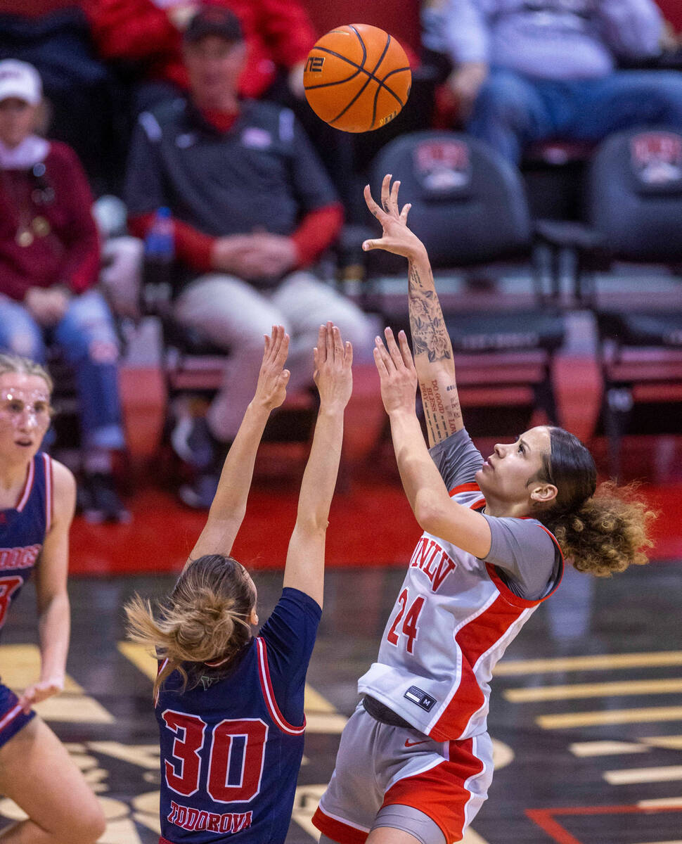 UNLV Lady Rebels guard Essence Booker (24) elevates to short over Fresno State Bulldogs guard Y ...