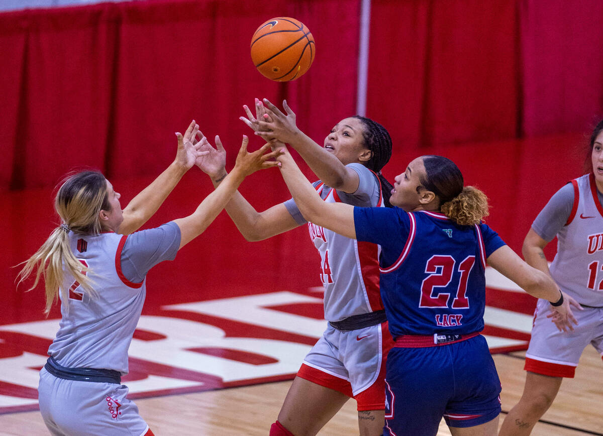 UNLV Lady Rebels guard Kenadee Winfrey (2) and teammate forward Alyssa Brown (44) fight to secu ...