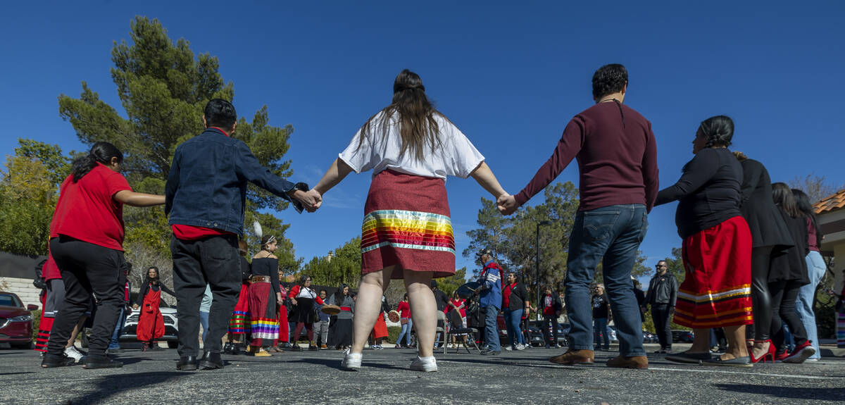 Members of the Native community and allies participate in a round dance as they gather in solid ...