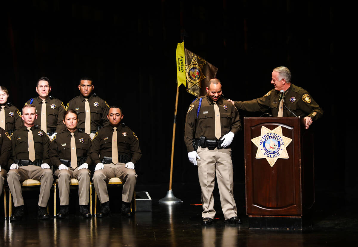 Clark Country Sheriff Joe Lombardo congratulates distinguished recruit Jose Grullon at the Metr ...