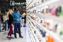 People browse shoes at Urban Necessities inside of the Forum Shops at Caesars in Las Vegas, Fri ...