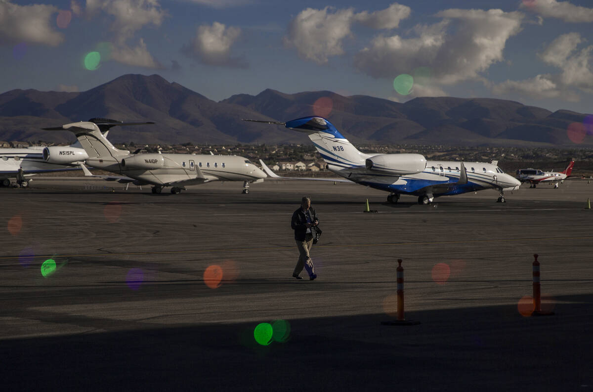 A passenger walks to the terminal after landing at Henderson Executive Airport on Dec. 5, 2019, ...
