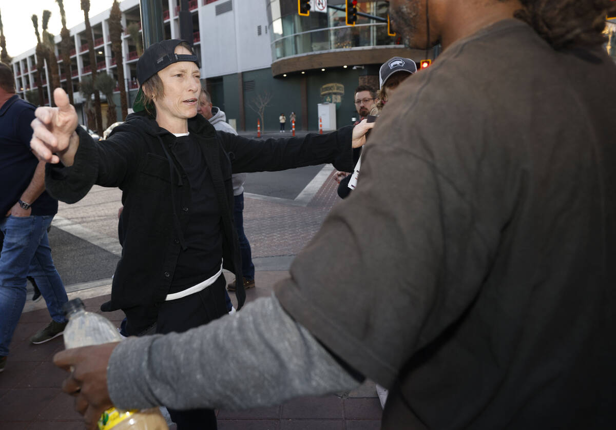 Jennifer Best of Las Vegas hugs a man who shows his support as she hands out missing person fly ...