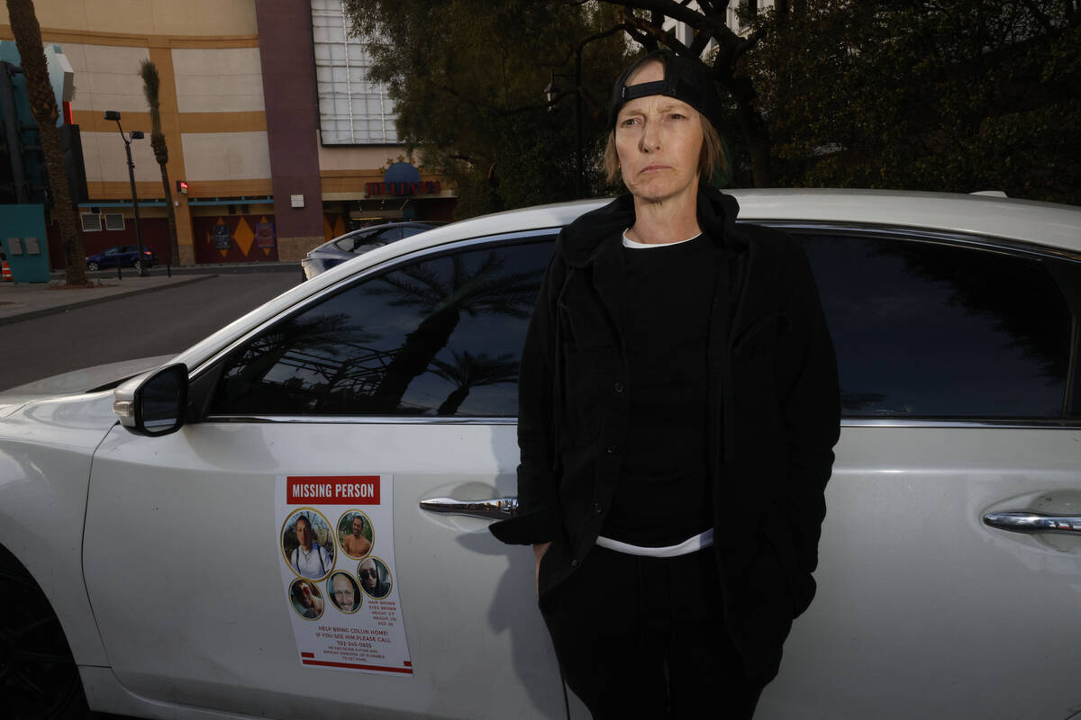 Jennifer Best of Las Vegas stands by her car posted a missing person flyer at downtown Las Vega ...