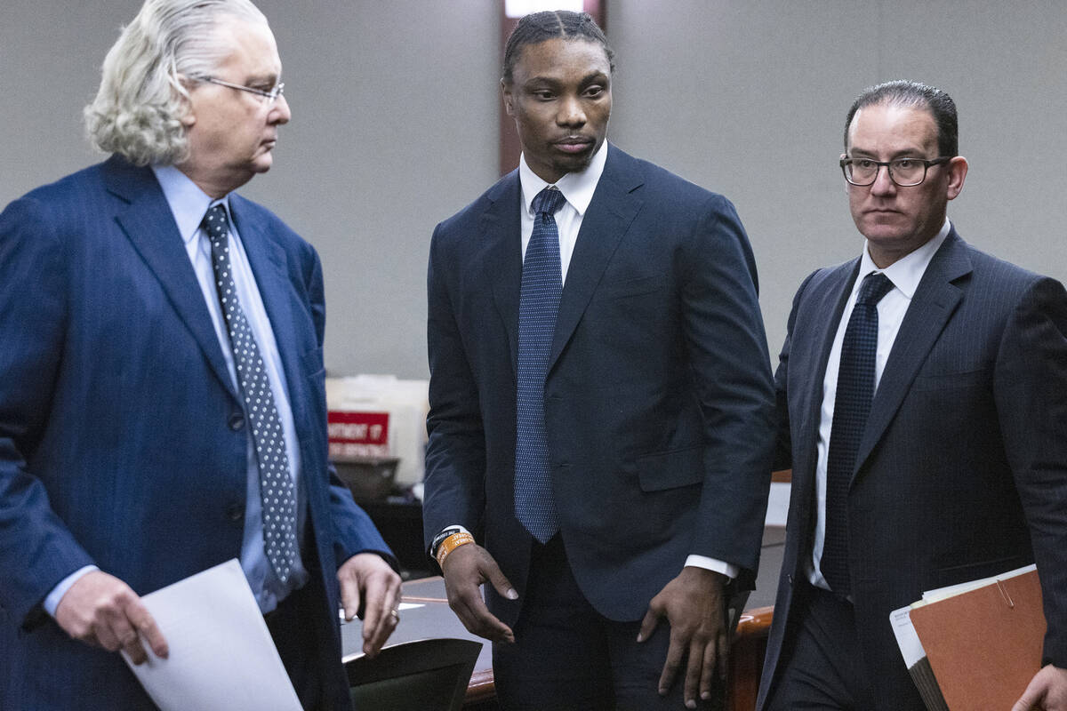 Ex-Raiders wide receiver Henry Ruggs, center, leaves the courtroom with his attorneys David Che ...
