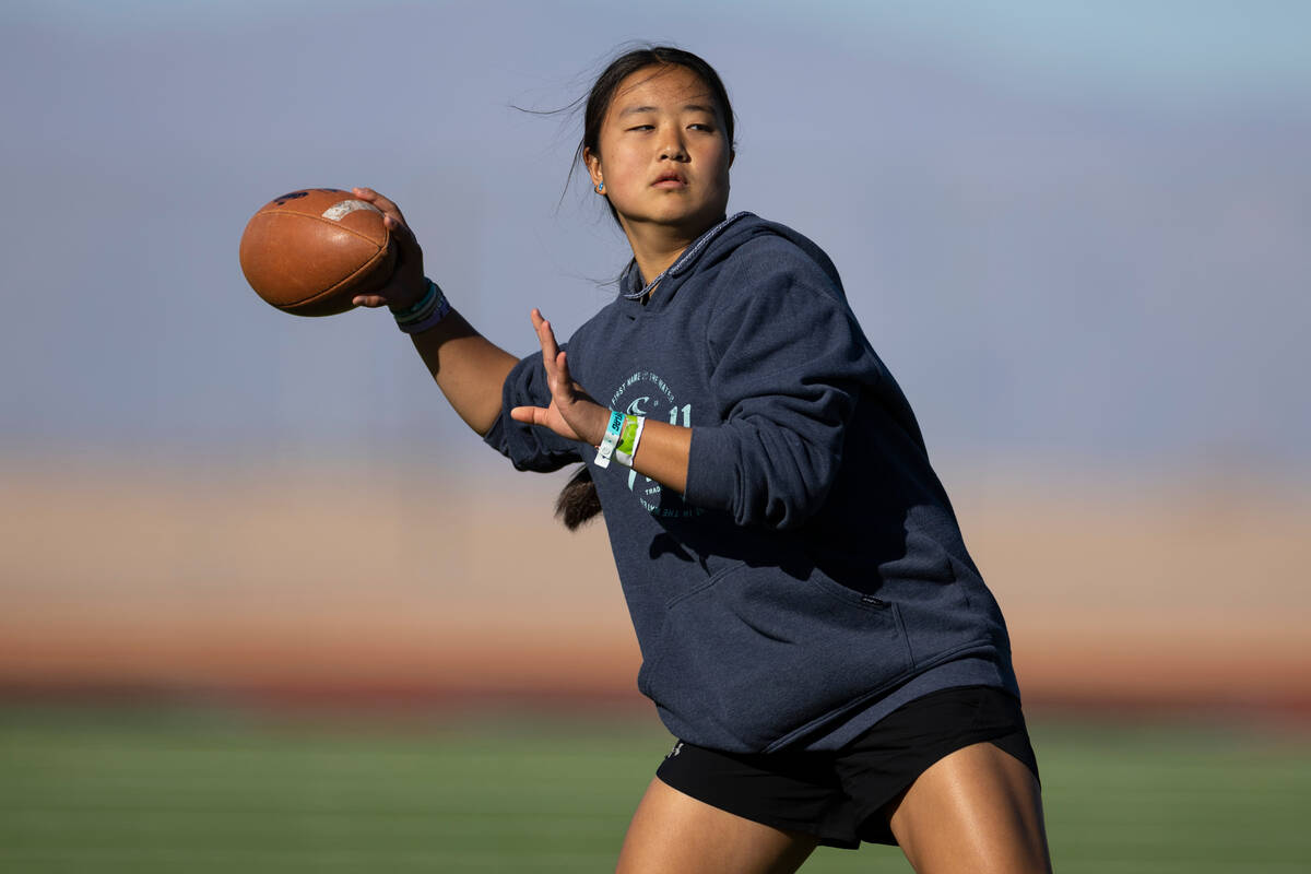 Akemi Higa gets ready to throw a ball during a flag football practice at Desert Oasis High Scho ...