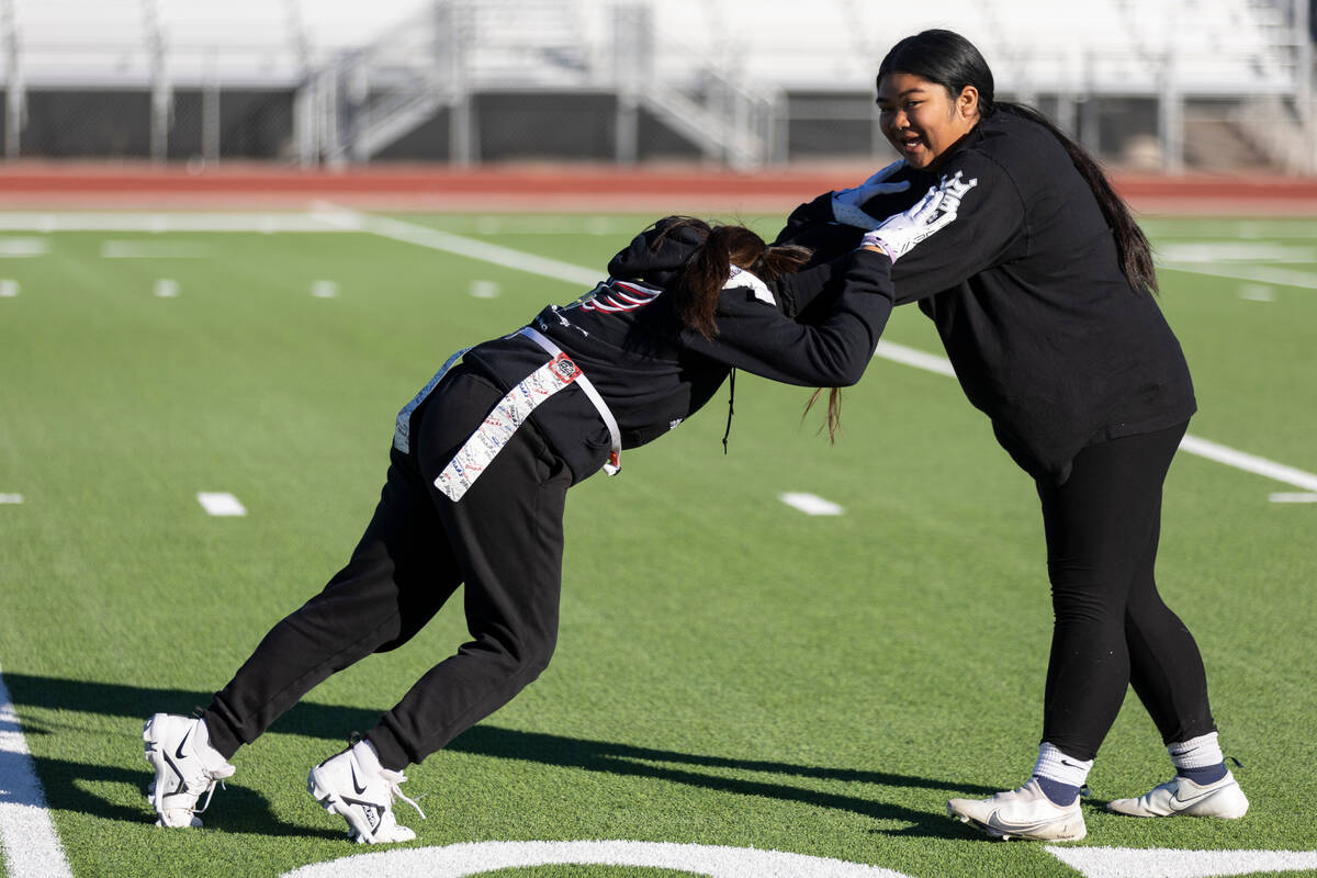 Tehani Koanui, left, and Jonee Perez, participate during a flag football practice at Desert Oas ...
