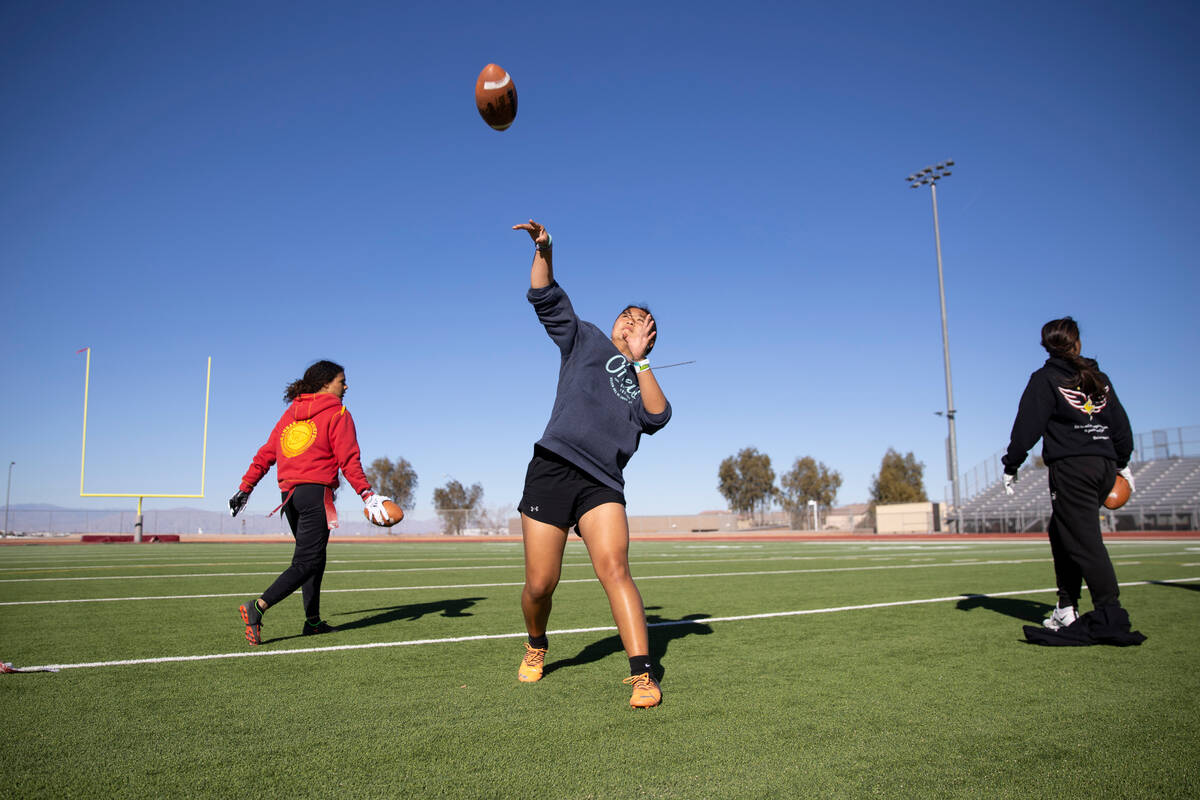Akemi Higa throws a pass during a flag football practice at Desert Oasis High School in Las Veg ...