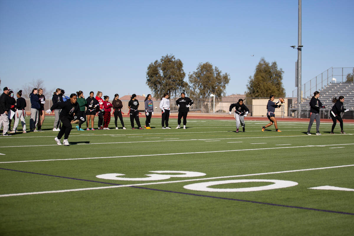 Players participate during a flag football practice at Desert Oasis High School in Las Vegas, T ...