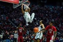 San Diego State guard Matt Bradley hangs on the rim after a dunk during the first half of an NC ...