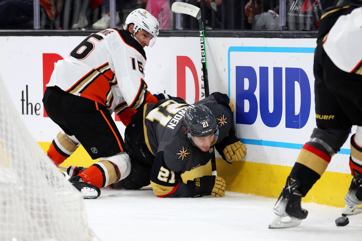 Vegas Golden Knights center Brett Howden (21) takes a fall while fighting for the puck against ...