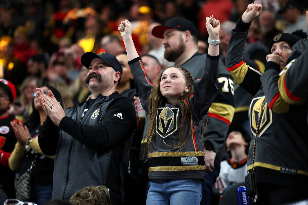 Fans celebrate a goal by the Vegas Golden Knights during the first period of an NHL hockey game ...