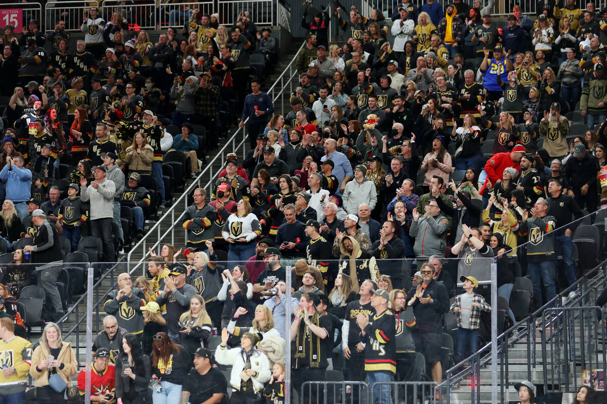 Fans celebrate after a Vegas Golden Knights goal during the third period of an NHL hockey game ...