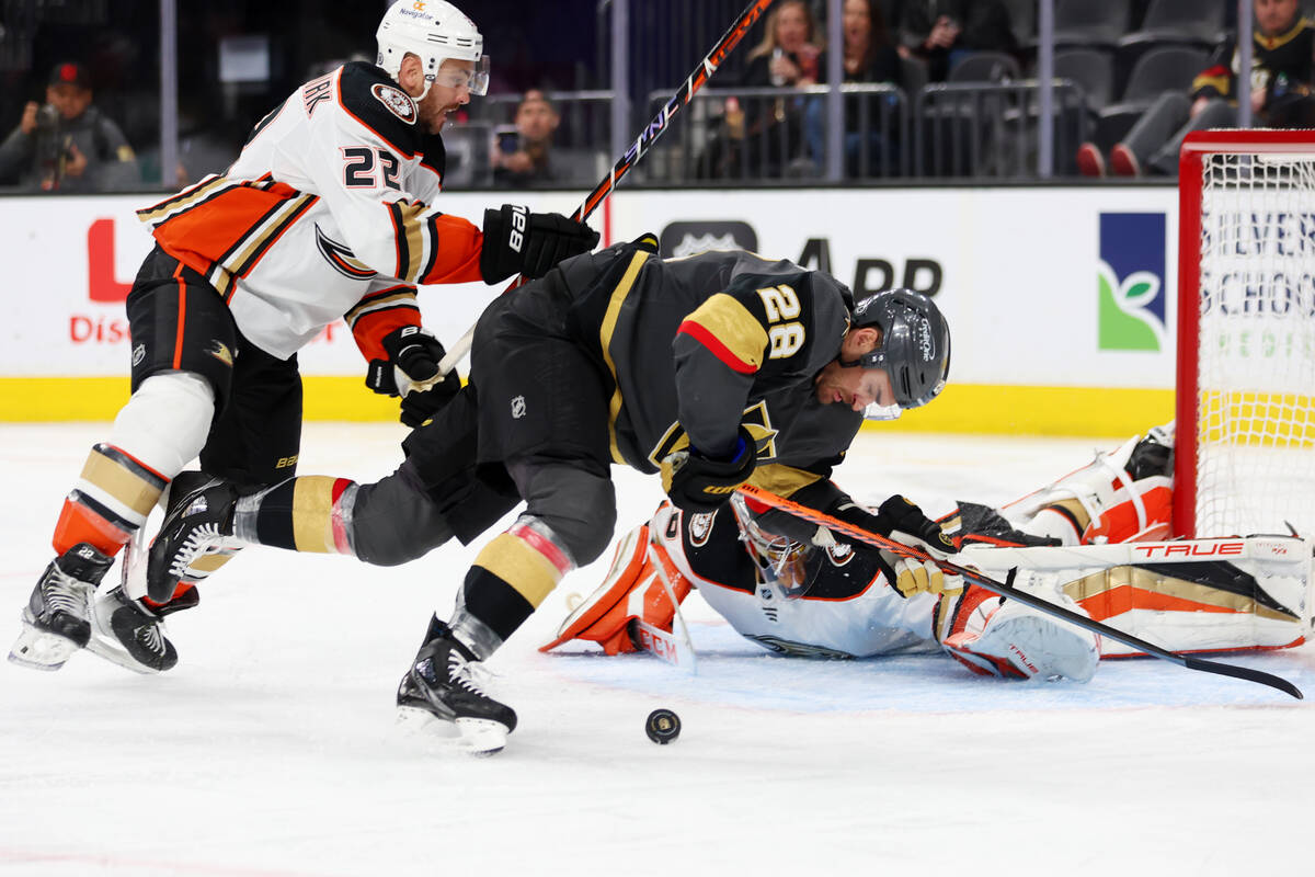 Vegas Golden Knights left wing William Carrier (28) takes a fall under pressure from Anaheim Du ...
