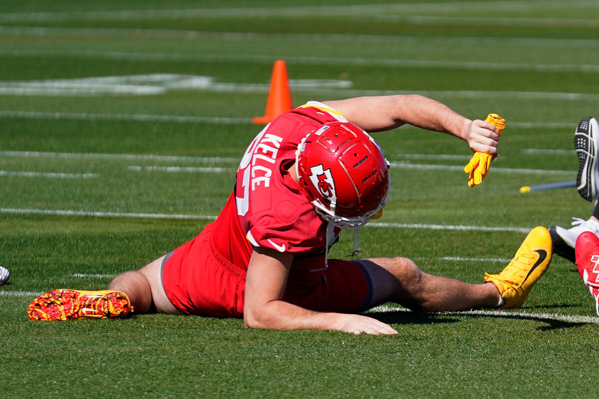 Kansas City Chiefs tight end Travis Kelce stretches during an NFL football practice in Tempe, A ...