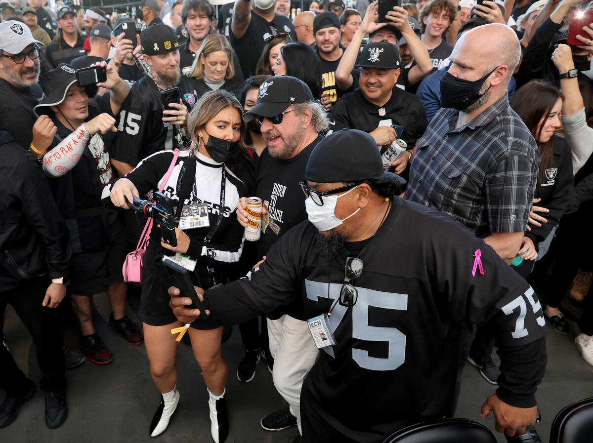Sammy Hagar is surrounded by fans after performing during halftime as the Raiders take on the C ...
