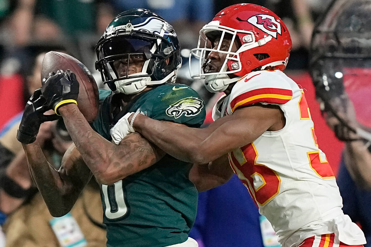 Philadelphia Eagles wide receiver DeVonta Smith, left, cannot catch a pass while being defended ...