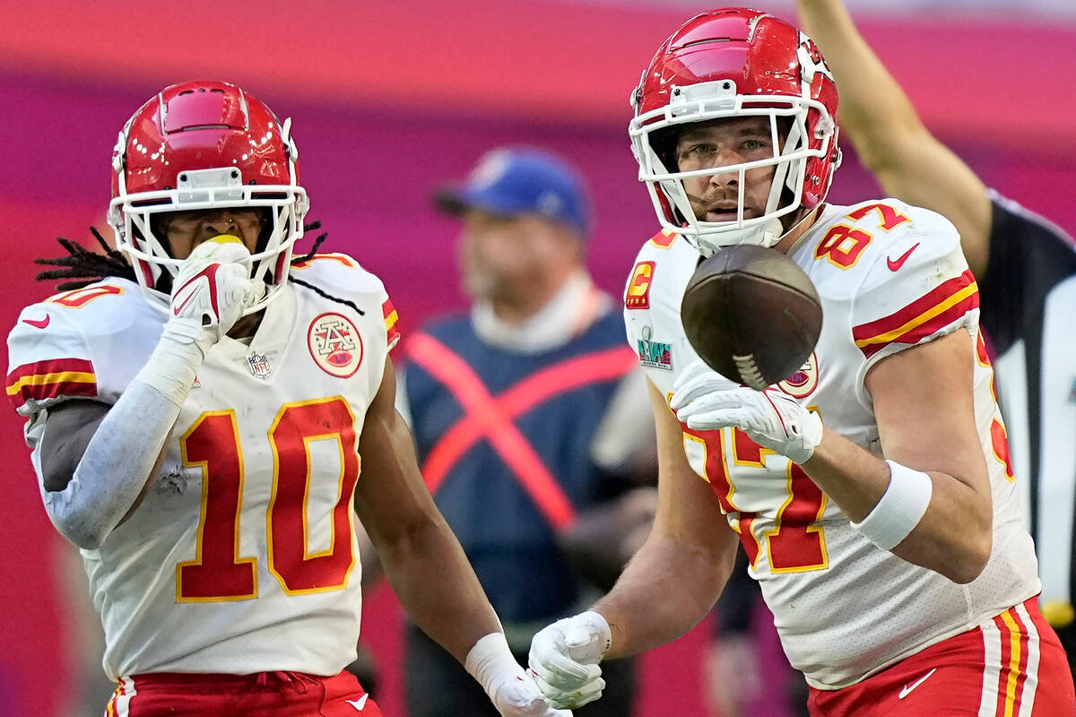 Kansas City Chiefs tight end Travis Kelce (87) celebrates his catch with running back Isiah Pac ...