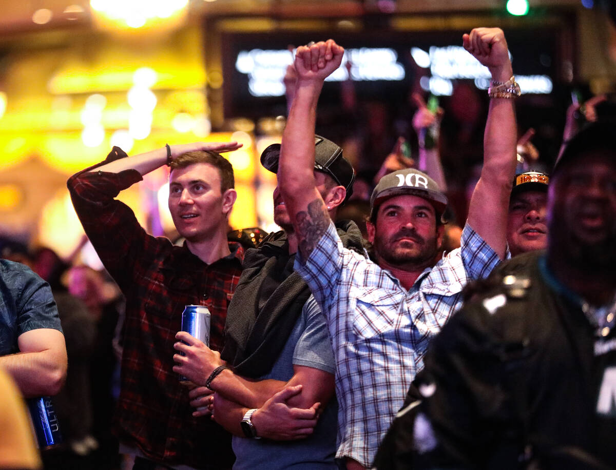 Attendees react to Super Bowl LVII at Caesars Palace sportsbook in Las Vegas, Sunday, Feb. 12, ...