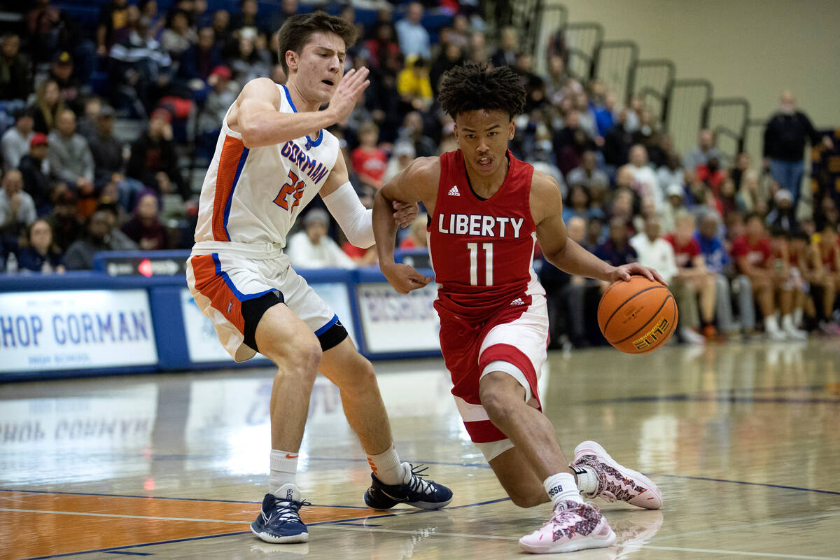 Liberty’s Dedan Thomas Jr. (11) dribbles around Bishop Gorman’s Ryder Elisaldez ( ...