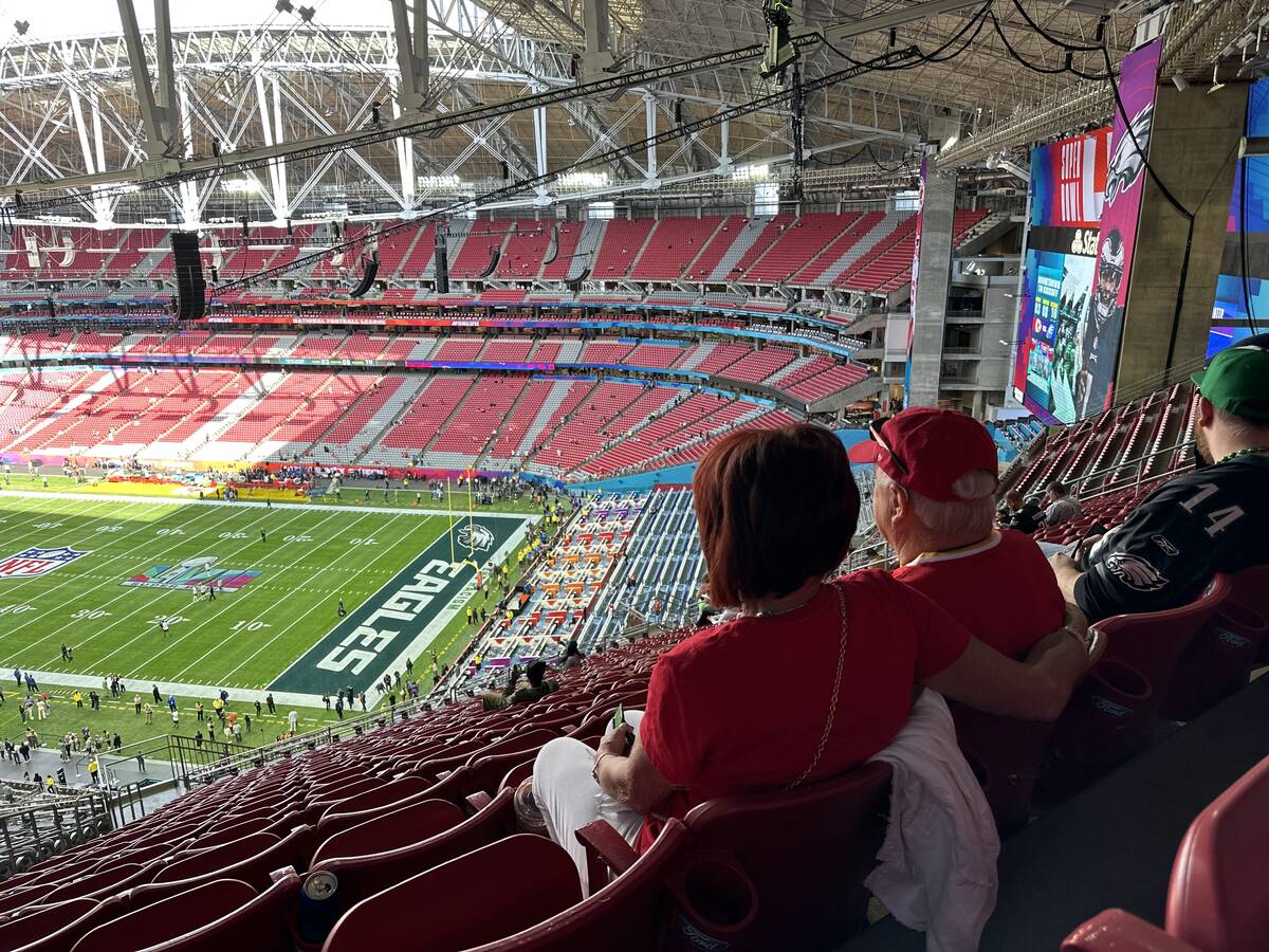 Cindy and Woody Moses look out toward the field at State Farm Stadium in Glendale, Arizona Sund ...