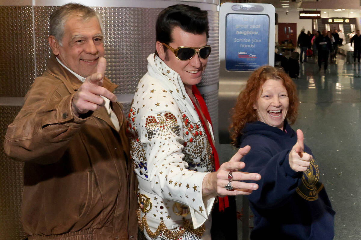 Brian Mills as Elvis poses with Kerry Riehl and Ben Makkinje of Colorado Springs, Colo. after t ...