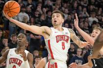 UNLV guard Jordan McCabe (5) shoots the ball as Utah State guard Sean Bairstow (2) defends duri ...