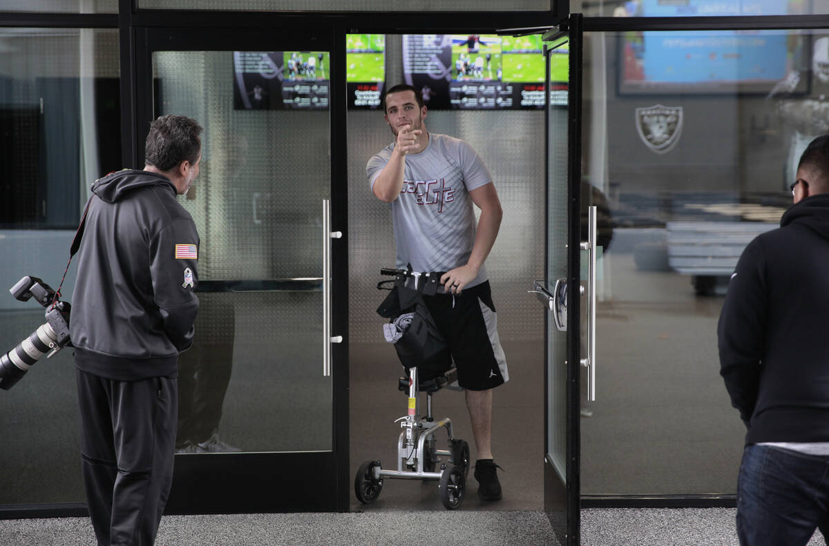 Oakland Raiders' quarterback Derek Carr, with his broken leg is seen at Raider headquarters in ...