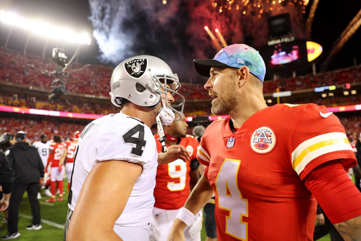 Raiders quarterback Derek Carr (4) and Kansas City Chiefs quarterback Chad Henne (4) speak to e ...