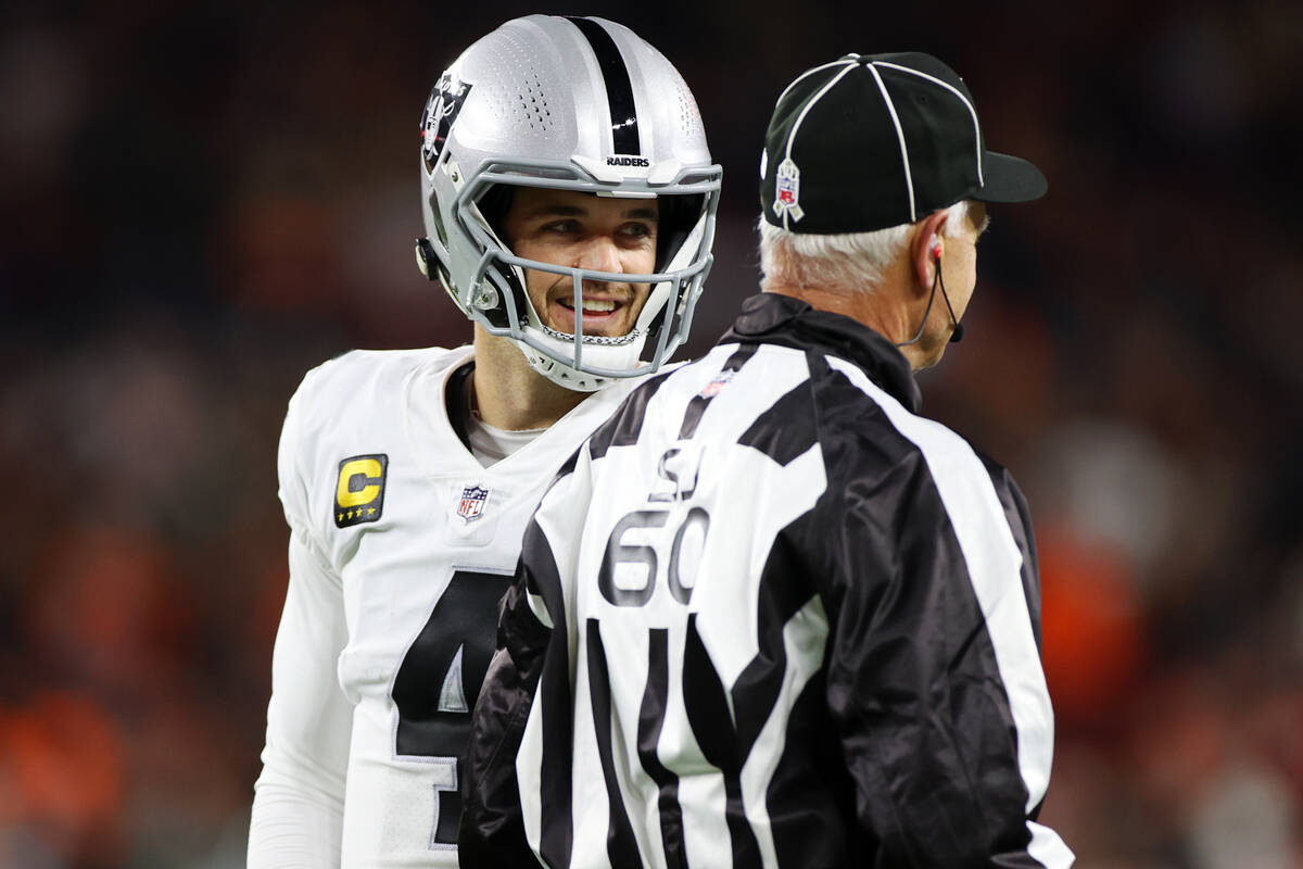 Raiders quarterback Derek Carr (4) talks to a game official during the first half of an NFL foo ...