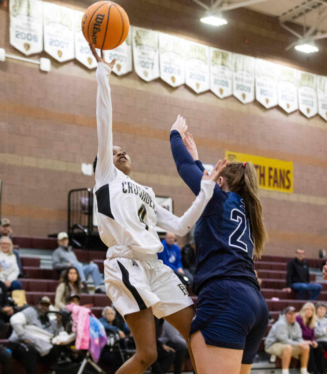 Faith Lutheran's Tamiah Harrison (4) recovers the rebound as Spring Valley's high Delaney Bartl ...
