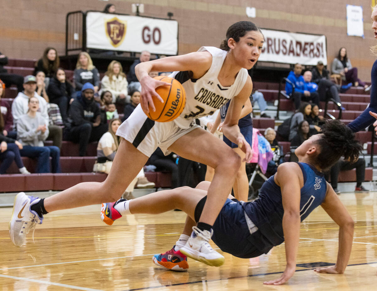 Faith Lutheran's Leah Mitchell (34) collides with Spring Valley's high Mia Ervin (1) during the ...
