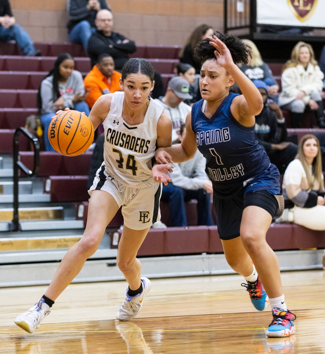 Faith Lutheran's Leah Mitchell (34) drives past Spring Valley's high Mia Ervin (1) during the f ...