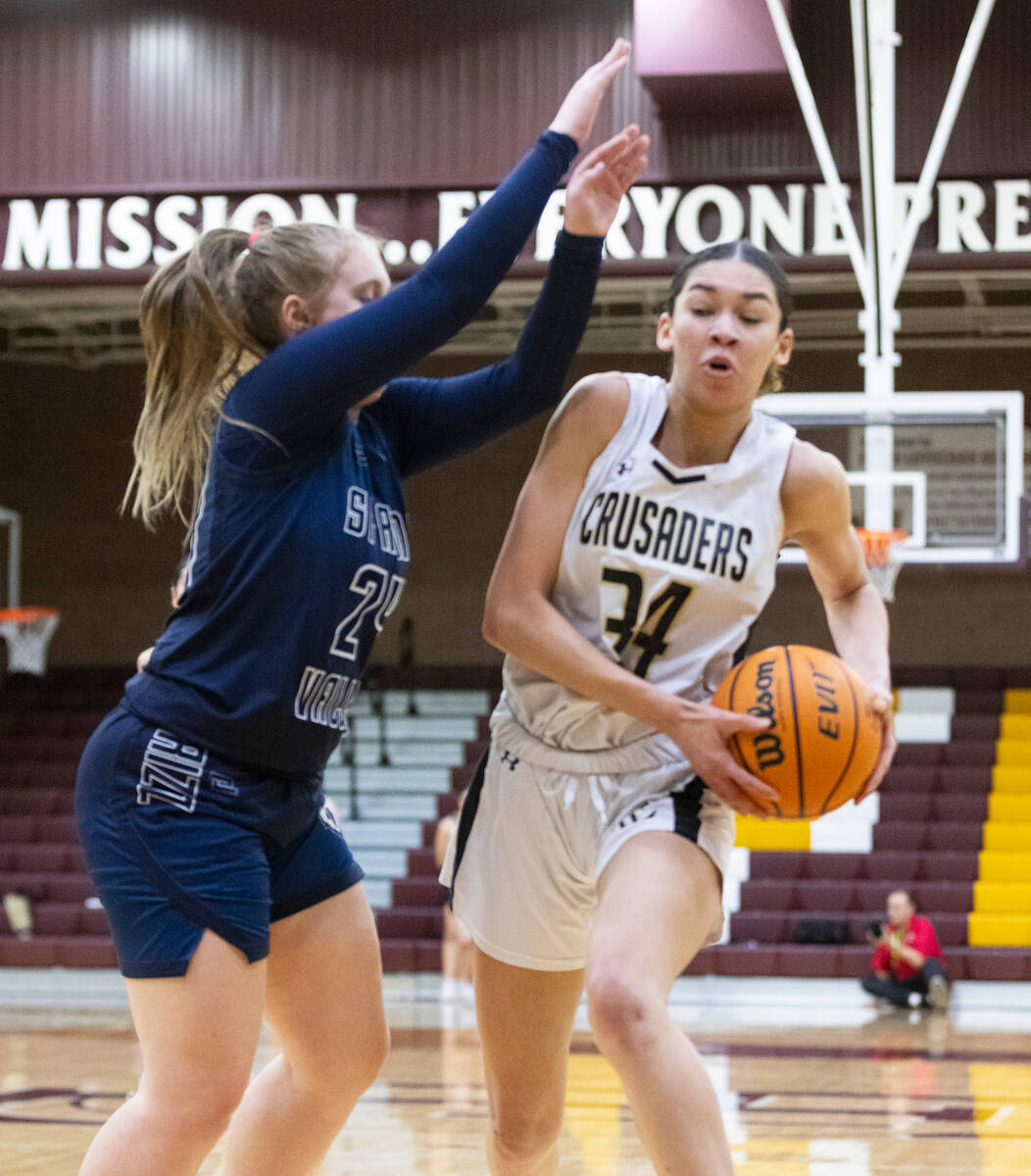Faith Lutheran's Leah Mitchell (34) passes the ball around Spring Valley's high Delaney Bartlet ...
