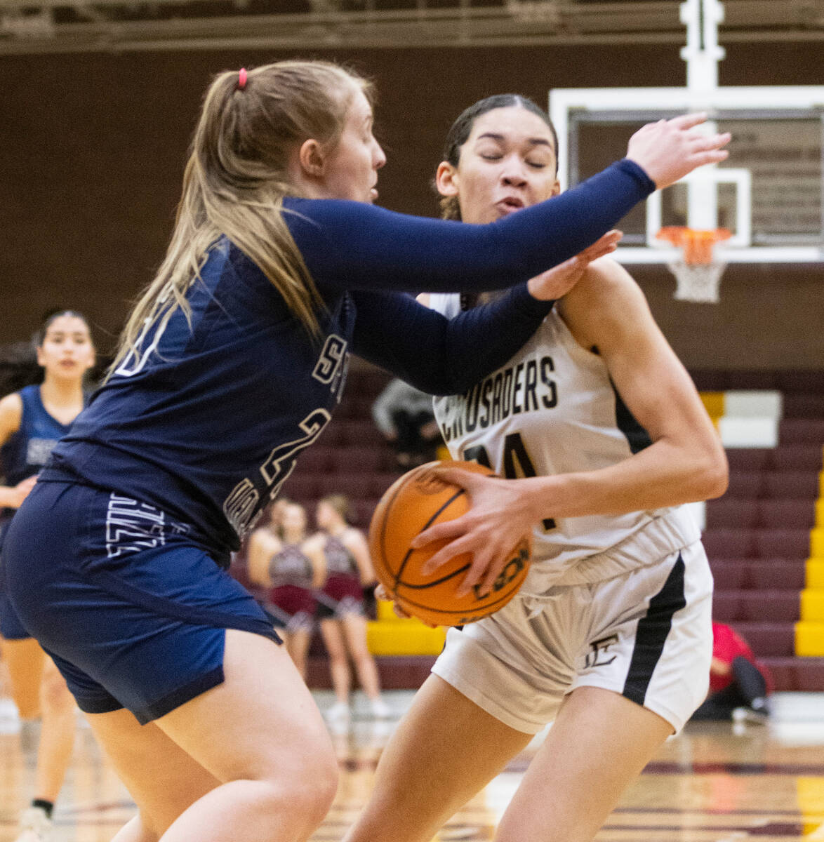 Spring Valley's high Delaney Bartlett (24) defends Faith Lutheran's Leah Mitchell (34) during t ...