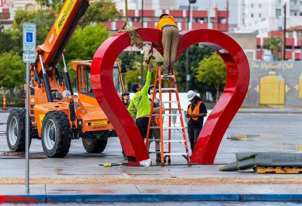 A crew erects a giant heart at the Llama Lot in preparation for the Life is Beautiful festival ...