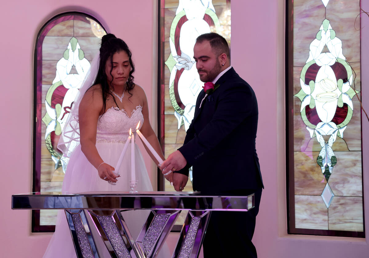 Cristian Sanchez and Juramys Valdes of Las Vegas get married at Vegas Weddings chapel in downto ...