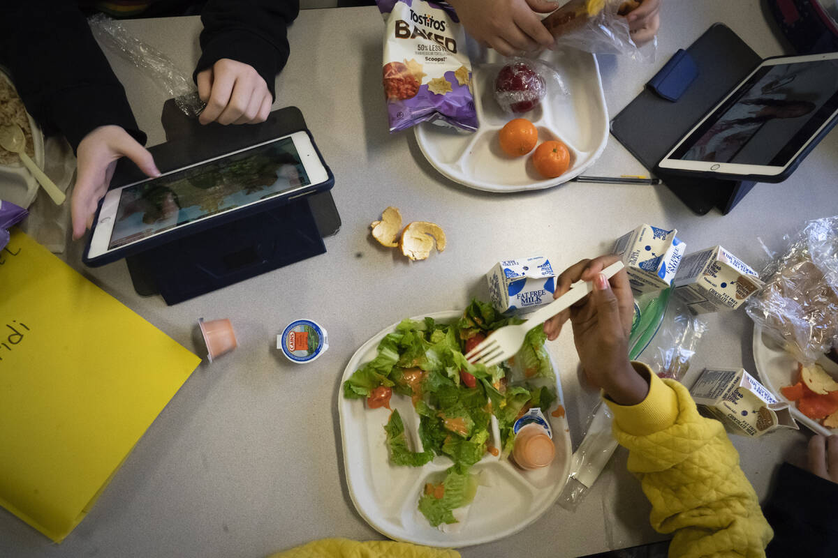 Seventh graders sit together in the cafeteria during their lunch break at a public school, Frid ...