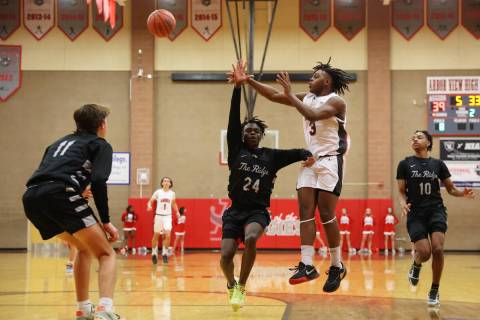 Arbor View's Brian Townsend (3) makes a pass under pressure from Shadow Ridge's Kene Udom (24) ...