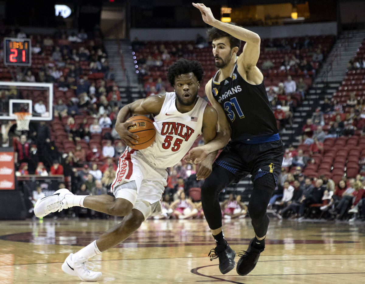 UNLV Rebels guard EJ Harkless (55) dribbles around San Jose State Spartans forward Tibet Gorene ...